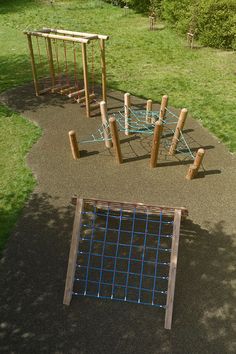 an aerial view of a playground in the middle of a grassy area with swings and climbing bars