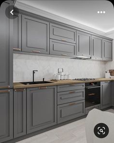 an image of a kitchen setting with grey cabinets