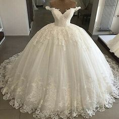 a white wedding dress on display in front of a mirror