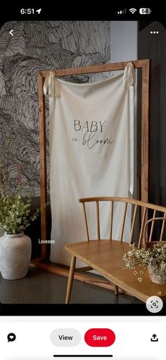 an image of a baby shower curtain on the wall in front of a wooden chair