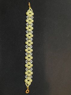 This beautiful bracelet is made with 6mm yellow pearls and 6mm bicone crystals. Elegant Yellow Beaded Bracelets For Jewelry Making, Elegant Yellow Beaded Bracelet With Faceted Beads, Adjustable Yellow Beaded Bracelets, Elegant Yellow Polished Beaded Bracelets, Elegant Yellow Bracelets With Faceted Beads, Elegant Yellow Bracelet With Faceted Beads, Elegant Yellow Beaded Crystal Bracelet, Elegant Yellow Bracelets With 8mm Beads, Elegant Yellow Crystal Bracelet With Round Beads