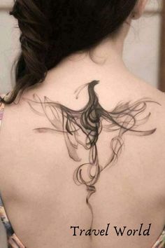 the back of a woman's neck with a bird tattoo on it