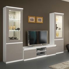 a living room with white and grey furniture in the center, including a flat screen tv