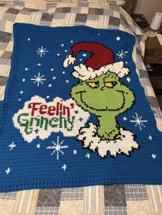 there is a crocheted blanket that has the grin on it and says feh gneely