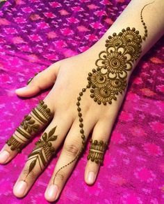 henna tattoo on the palm of a woman's hand