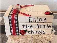 a stack of books with ladybugs on them and the words enjoy the little things