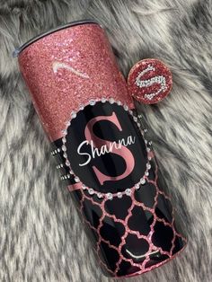 personalized glitter tumbler with monogrammed name and initial on it, sitting on a fur surface