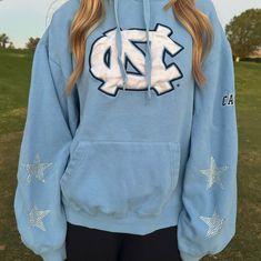 Vintage University of North Carolina at Chapel Hill Hoodie with added star rhinestones. One of a kind, embroidered, and super cute! So comfy!  Wash delicate and dry with low heat or hang dry Size XL. Feels true to size, not very oversized. The model is a size small. It is used and second hand but there are no stains or rips. Cotton Long Sleeve Hoodie With Star Print, Cotton Long Sleeve Sweatshirt With Star Patch, Winter Cotton Top With Star Patch, Winter Cotton Tops With Star Patch, Star-shaped Cotton Sweatshirt For Winter, Fall Cotton Sweatshirt With Star Patch, Winter Cotton Sweatshirt With Star Print, Fall Star Print Cotton Sweatshirt, Fall Cotton Sweatshirt With Star Print