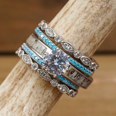 three rings with blue and white stones on them