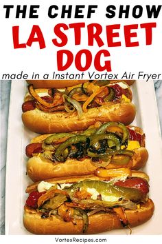 three hot dogs with toppings on them sitting in a white tray next to the words, the chef show la street dog made in instant vortex air fryer