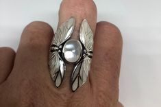 Lovely polished sterling silver has the look of Deco with a huge white Mother Of Pearl inlaid Lunar moth very detailed vintage filigree We can size these with an additional $20 fee for the jeweler All rings are shipped in a nice gift box. Check out our over a THOUSAND great reviews!!! Engraving is $4 per letter and is not always perfect depending on the piece. It can take a few days if the jeweler is busy. This is payable to Paypal Judithsltd@gmail.com Vintage Silver Handmade Moonstone Ring, Vintage Handmade Silver Moonstone Ring, Elegant White Sterling Silver Butterfly Ring, Art Deco White Ring Jewelry, White Art Deco Ring Jewelry, White Art Deco Jewelry Ring, White Art Deco Ring, Sterling Silver Jewelry With White Inlay, White Sterling Silver Jewelry With Inlay