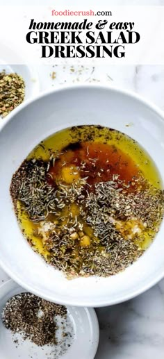 a white bowl filled with greek salad dressing on top of a marble counter next to two plates