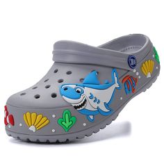 PRICES MAY VARY. Cartoon Shark Sandal Clogs - The perfect summer sandal brings joy to children. Cute designs for boys and girls. Sizes for ages approximately 4 to 10 years old. Breathable and quick drying - The water shoes with ventilation holes design can keep your kid's foot drying and feeling more comfortable. Non-slip and safety - Perfect Support-ability Cushion Garden Clog Shoes for Kids, Non-slip outsole allows for good grip on slippery surfaces. Lightweight and easy care - These kids slip Cartoon Slide, Unicorn Slippers, Shower Slippers, Kids Clogs, Boys Slippers, Pool Shower, Shoe Storage Solutions, Garden Shoes, Garden Clogs