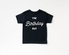 "If you love retro designs as much as I do, this \"the birthday boy\" shirt is the perfect option for your little boy! This shirt is perfect for all ages: the first birthday, second birthday, third birthday and beyond! + This is a screen printed Bella + Canvas shirt. + Please reference all size charts before purchasing. + The default ink color on white shirts is black and for black shirts it's white, unless otherwise listed in the Color & Style drop down menu. The choice after the \"with\" on ea Birthday Second, Birthday Graphic, Birthday Boy Shirt, Black Shirts, Birthday Boy Shirts, Boy Shirt, Second Birthday, Third Birthday, Retro Designs