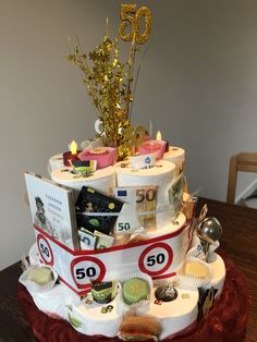 a 50th birthday cake made to look like a boat with 50 cents on the side