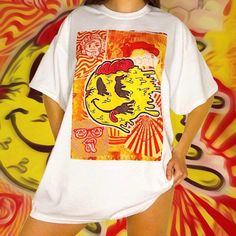 🚧 Yellow & Orange Trippy Festival Graphic T-Shirt 🚧 An original hand drawn graphic design by Mikiko! 👁 FREE WORLDWIDE SHIPPING 👁 Unisex t-shirts available in sizes  - Small - Medium - Large - XL - XXL (other sizes can be made upon request) - Ethically and sustainably manufactured - Artwork is professionally printed - no cracks or peeling - High quality heavy tee with a taped neck and sleeves - Authentic artwork - Machine wash inside out for best results (Hand-wash works even better) - Intern 90s Rave Aesthetic, 80s Poster, Yellow Y2k, Rave Shirts, Y2k Graphic Tees, Retro Streetwear, Smiley Faces, Oversize Fashion, 90s Nostalgia