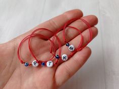 This listing is for 1 red bracelets. The  bracelet is made with a cotton thread slim red string, 1 plastic bead with letter and 1 blue plastic bead. Easily adjustable by moving the knots closer or away. This red string bracelet will help to protect you. This bracelet is made for guard against the evil eye. The bracelet is unisex with adjusted length.   Please select a size! Size of the element letter made of steel: 4 x7 x1 mm Please select the letter you want! Personalized Red Beaded Bracelets With Letter Beads, Personalized Red Letter Beads Bracelet, Adjustable Red Beaded Bracelets For Personalized Gift, Red Adjustable Jewelry For Personalized Gift, Adjustable Red Jewelry For Personalized Gifts, Baby Letters, Red Bracelet, Bracelet Initial, Red String Bracelet