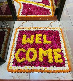 two cakes decorated with flowers and the words del cume on them are displayed in front of a mirror