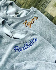 This embroidered crew neck collar sweatshirt, is personalization on the left side of the collar. Choose from your mascot, name, saying or anything that will fit.  Great for a personalized sports season, birthday gift, mama, grandma or school spirit. Sweatshirt is a unsex size either Hanes or Gildan, whichever is in stock.  Sport Grey is the sweatshirt color shown. *A picture of all the letters of this font are in the listing photos. I will use the lower and uppercase letters you provide in your order. If you don't like the shape of the letter(s) after you received your order I will not redo your item. Please take a look before ordering.  In the personalization box tell me the word or words and thread colors you would like. 10 Letters Max. Font stays the same. Embroidery is stitched in my s Sports Embroidery, Collar Sweatshirt, Collared Sweatshirt, Embroidered Sweatshirt, Uppercase Letters, Personalized Embroidered, Letter S, Embroidered Sweatshirts, School Spirit