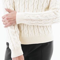 Introducing a modern, feminine version of the classic fisherman's sweater: the Fischer Sweater! While this sweater nods to tradition with beautiful alternating rows of cable knit along the body and by utilizing wool, small details bring this style into 2023. First and foremost, we love the enhanced softness and more pleasant handfeel of the knit, which is a blend of luxurious merino wool and acrylic. The length of the sweater is also very flattering and feminine, hitting right at the hip. The mo Elegant Cable Knit Winter Sweater, Winter White Cable Knit Sweater, Classic Fitted Cable Knit Cardigan, Fitted Classic Cable Knit Cardigan, Fitted Classic Sweater In Winter White, Classic Fitted Winter White Sweater, Fitted Classic Winter White Sweater, Elegant Winter White Cable Knit Sweater, Elegant Cable Knit Turtleneck Sweater