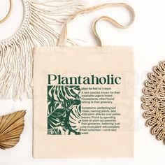 Elevate your plant-loving style with our "Plantaholic" Canvas Tote Bag! This groovy, eco-friendly bag is perfect for all you house plant enthusiasts out there. Featuring a bold design printed on both sides, you'll make a statement coming and going. Whether you're hitting up the farmer's market, cruising through a plant nursery, or just need a bag for your everyday adventures, this tote has got your back. It's spacious, durable, and ready to carry all your plant goodies.🌱✨ Key Features: Dual-Sid Eco-friendly Rectangular Bag With Plant Print, Eco-friendly Everyday Bag With Plant Print, Green Canvas Bag With Eco-friendly Ink As Gift, Garden Bags, Sustainable Shopping, Eco Friendly Bags, Everyday Adventures, Gym Gear, Plant Lover Gift