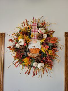 a wreath that says fall with an image of a scarecrow and pumpkins on it