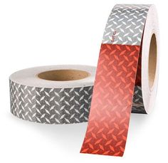 a roll of silver and red tape with an arrow pattern on it's side