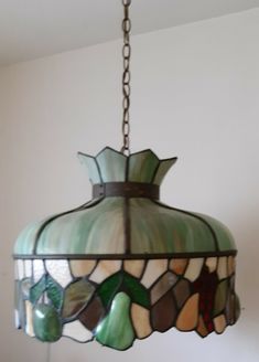 a stained glass lamp hanging from a ceiling