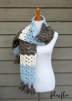 a crocheted scarf on a mannequin