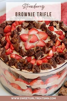 strawberry brownie trifle in a glass dish with strawberries on top and the title overlay reads strawberry brownie trifle