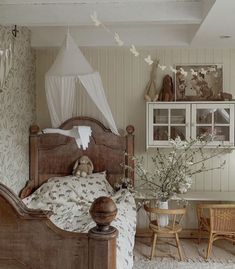 a bed sitting in a bedroom next to a wooden table