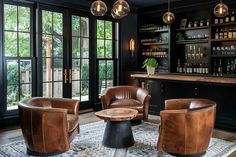 a living room filled with lots of furniture next to a window covered in glass doors