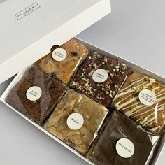 a white box filled with different types of desserts