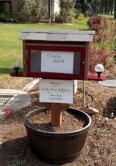 a mailbox sitting on top of a wooden barrel