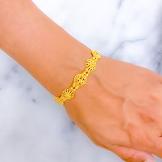 This 22k gold bracelet features a lovely decorative design that blends elegance with intricate craftsmanship. Weighing 9.0 grams, the bracelet showcases a lustrous yellow gold finish and measures 7.5 inches in length, with adjustable 1.4-inch links for a tailored fit. The secure hook lock ensures both style and ease of wear. The detailed, ornate design adds a touch of sophistication, making this bracelet a perfect choice for those who appreciate refined beauty and timeless charm. Ideal for both everyday elegance and special occasions. PRODUCT DETAILS Gold Purity(karat): 22k Gold Weight(grams): 9.0 Item Finish: Yellow Gold Bracelet Length: 7.5" Adjustable Links: 1.4" Links Lock Style: Hook Lock 22k Gold Bracelet, Ornate Design, Lock Style, Everyday Elegance, Decorative Design, Yellow Gold Bracelet, 22k Gold, Gold Finish, 4 Inch