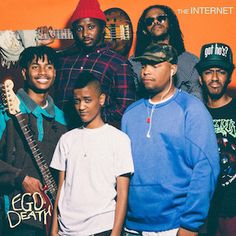 a group of young men standing next to each other in front of an orange background