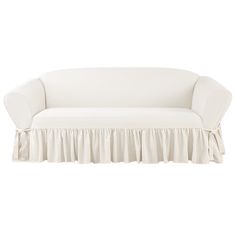 a white couch with a ruffled skirt on it's back and the seat upholstered