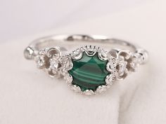 Welcome to my shop, you can find many beautiful gemstone jewelry here, and you also can ask for customized service.  Please notice  malachite is a natural gemstone,each one is similar but not the same Main Stone: Real malachite, round cut 7 mm  Accent Stones: CZ Metal: 925 sterling silver plated with rhodium so as to protect the ring from tarnish and keep it shinning. I also can provide metal options such as 14k solid yellow/white/rose gold Setting: bezel setting  more rings: https://www.etsy.co Malachite Wedding Ring, Malachite Engagement Ring, Filligree Ring, Meaningful Rings, Malachite Ring, Design Your Own Ring, Filigree Engagement Ring, Malachite Rings, Malachite Jewelry