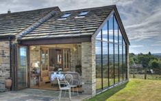 an image of a house that is in the middle of the day with glass walls