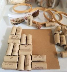 some wine corks are laying on a table next to rolls of tape and other crafting supplies