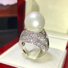 Enormous SOUTH SEA PEARL, absolutely natural color and luster, 14.5 mm in size, surrounded by 257 pieces of hand-set E/VVS superb quality diamonds, weighting at 3.05 carats. Set in handcrafted, one of a kind 18K solid white gold ring, weighting at 13.5 grams. The pearl is naturally cultured from South Australia Sea, its luster is extra fine, AA+ grade with 85% clean surface. SUGGESTED RETAIL PRICE: $13,800 The ring is hand crafted to a high standard and is NOT mass machine produced and is brand Luxury White Diamond Ring For Party, White Pearl Ring For Parties, Dazzling White Rings For Evening, Luxury White Rings For Evening, Luxury White Evening Rings, White Diamond Party Ring, Luxury White Diamond Ring With Sparkling Detail, White Diamond Ring For Party In Fine Jewelry Style, White Diamond Ring For Party, Fine Jewelry