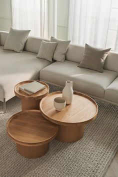 a living room filled with furniture next to a large white couch and table in front of a window