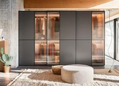 a living room filled with furniture next to a window covered in frosted glass doors