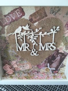 a photo frame with the word mr and mrs on it, surrounded by other items