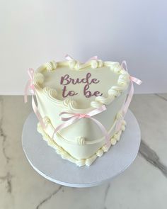 a heart shaped cake with the words bride to be written on it