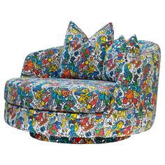 a multicolored couch with many cartoon characters on the back and arms, sitting in front of a white background