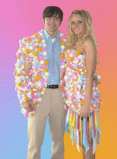 a man and woman are dressed up in colorful pom poms on their jackets