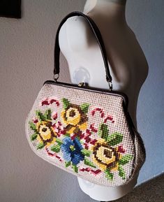 Beautiful vintage  wool with hand embroidered flowers  handbag in blue, yellow, green and red on beige baze. Outstanding 40s or 50s  tapestry needlepoint handbag on brass frame with brown leather trim. Good vintage condition, the lining is perfrctly. Has issue the leather trim the leather has injuries and two very small holes in the embroidery. Please look at the photos carefully because they are part of the description. Measurements: Height - 27 cm /10.8'' Width - 37 cm/14.6'' Depth - 7 cm/ 2.9 Vintage Embroidered Beige Bag, Vintage Beige Tapestry Bag, Vintage Embroidered Tapestry Shoulder Bag, Vintage Tapestry Multicolor Shoulder Bag, Vintage Embroidered Cream Bag, Vintage Cream Embroidered Bag, Vintage Beige Embroidered Shoulder Bag, Vintage Embroidered Tote Bag, Vintage Embroidered Bag For Daily Use