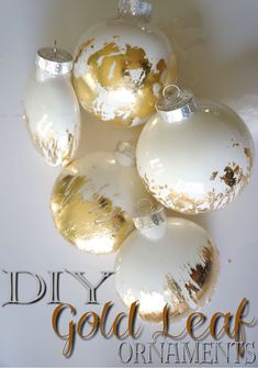 five white and gold ornaments with the words diy gold leaf ornament's