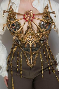 Stained Glass Full Corset Description Introducing the Stained Glass Corset, custom-made to your size. Please allow 8-10 weeks for production before shipping. Inspired by the magnificent cathedrals built during the Dark Ages, such as Prague's St. Vitus Cathedral and Cologne Cathedral, this corset captures the intricate beauty of stained glass patterns and ornate sculptures, offering a delicate and unique aesthetic. After much anticipation, the full Stained Glass Corset is now available for purcha Luxury Medieval Overbust Corset, Luxury Embellished Glamorous Corset, Luxury Romantic Corset For Costumes, Luxury Medieval Corset With Historical Design, Luxury Victorian Corset For Costumes, Luxury Elegant Corset For Costume, Luxury Fitted Medieval Style Corset, Luxury Romantic Costume Corset, Luxury Corset With Boning And Underwire